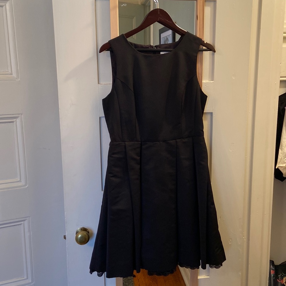 Simple black cocktail dress with lace trim on bottom